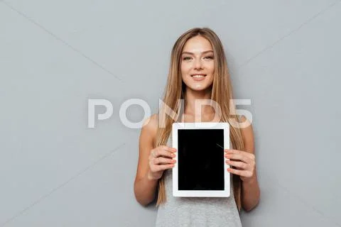 Smiling casual woman showing blank tablet computer screen Stock Photos