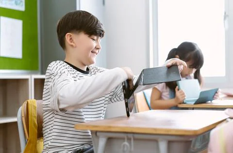 Smiling Caucasian boy preparing digital tablet for learning computer class Stock Photos