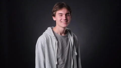 Smiling Caucasian Man Looking Into Camera on black Background Stock Footage 257447522