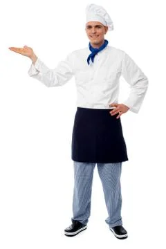 Smiling cehf pointing to a product Stock Photos