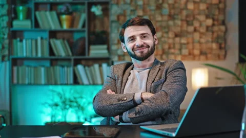 Smiling charismatic man office manager at his work place he showing to the Stock Footage 136554352