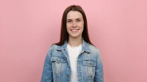 Smiling charming coquette friendly happy young woman looking camera Stock Footage 162843232