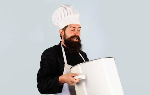 Smiling chef in apron with big pot or saucepan. Cooking and culinary. Bearded Stock Photos
