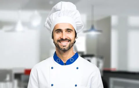 Smiling chef in his kitchen Stock Photos