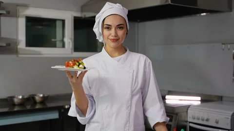 Smiling chef presenting fresh vegetable salad plate Stock Footage 299657114