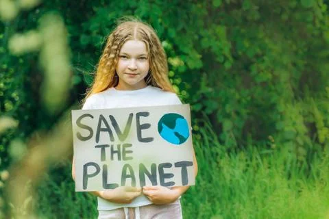 Smiling child looking to camera with save planet ecology poster in hands. sch Stock Photos
