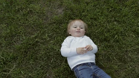 Smiling child lying on a grass Stock Footage 63011799