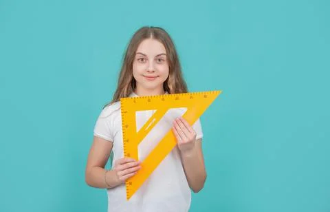 Smiling child with math triangle measuring tool Foto stock