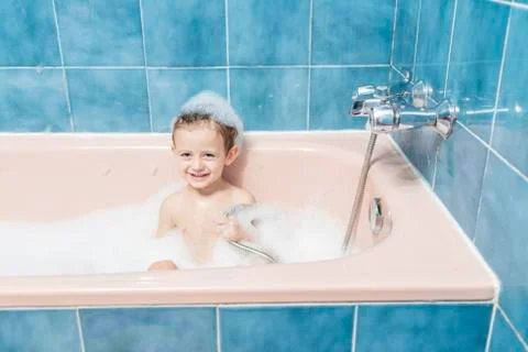 Smiling child playing in the bath Stock Photos
