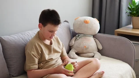 Smiling child solving puzzle with toy. Joyful engagement evident. Toy sparks Stock Footage 268439474