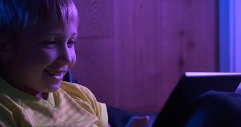 Smiling child with tablet.  Cheerful  boy  looks to the screen tablet and smi Stock Footage 118520863