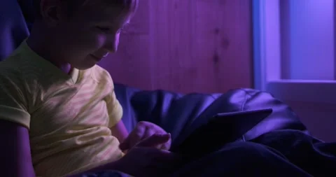 Smiling child with tablet.  Cheerful  boy  looks to the screen tablet and smi Stock Footage 150854077