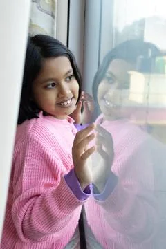 Smiling child at window Stock Photos
