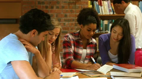 Smiling classmates studying in library Stock-Footage 57638693
