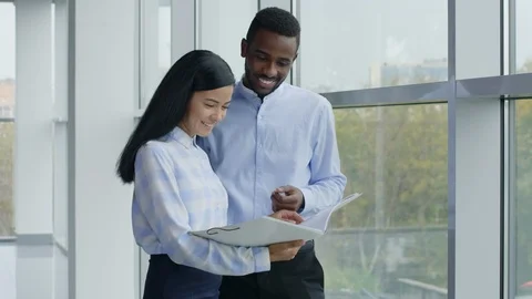 Smiling clerks with folder on workplace Видео 125708321