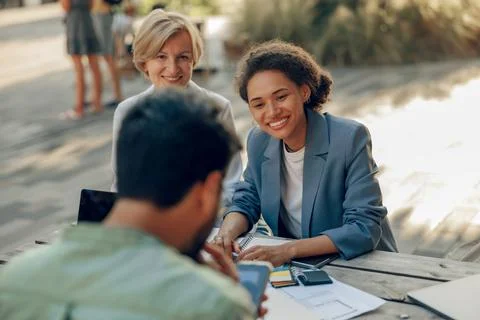 Smiling colleagues working together developing business strategy for project on Stock Photos