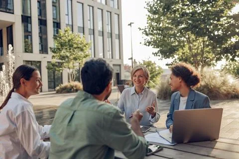 Smiling colleagues working together developing business strategy for project on Stock Photos