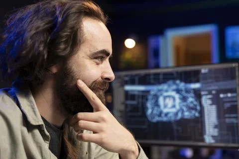 Smiling computer engineer updating AI, satisfied after finishing code script Stock Photos
