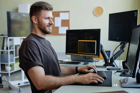 Smiling Computer Programmer at Workplace Stock Photos