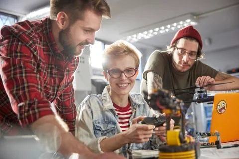 Smiling computer programmers programming robotics Stock Photos