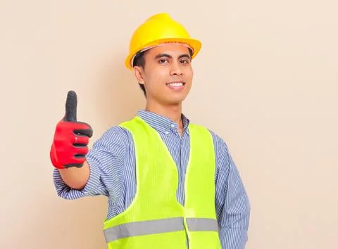 Smiling confident asian construction worker wearing safety vest and hard ha.. Stock Photos