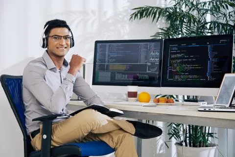 Smiling confident Indian coder Foto stock