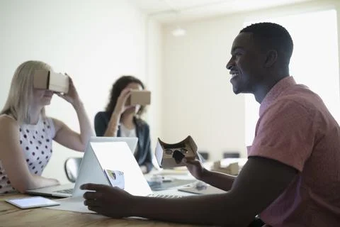 Smiling, confident male computer programmer designer testing virtual reality sim 스톡 사진