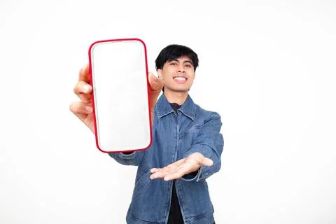 Smiling confident young man presenting a large blank smartphone screen on a.. Stock Photos