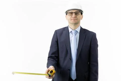 Smiling construction engineer in hard hat with measuring tape in hands Stock Photos