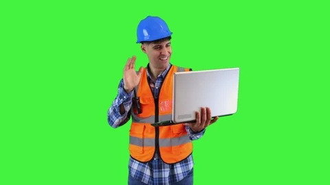 Smiling construction engineer making a video call with laptop, wearing oran.. Stock-Footage 286985850