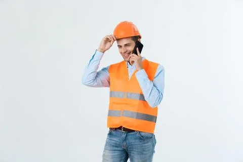 Smiling construction engineer posing isolated over grey background 스톡 사진