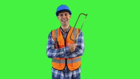 Smiling construction worker holding a hand saw ready to cut, wearing orange.. Stock Footage 286985998