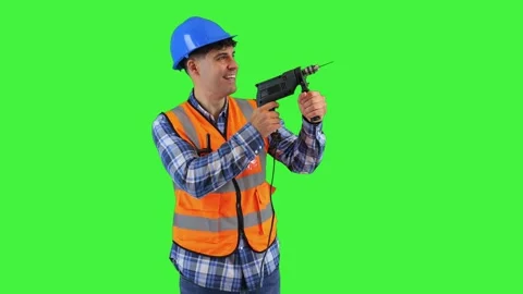 Smiling construction worker holding a power drill, wearing orange vest and .. Stock Footage 286986128