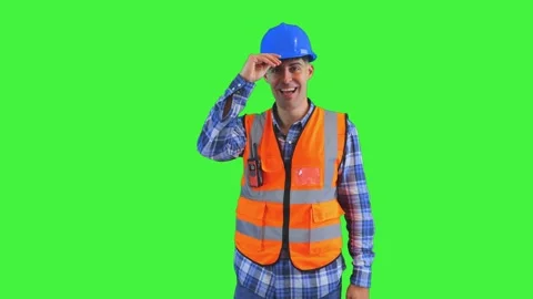 Smiling construction worker in orange reflective vest putting on safety hel.. Stock Footage 286985617