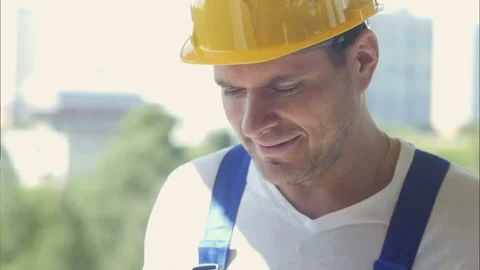 Smiling construction worker smiling and standing on building site Stock Footage 121481877