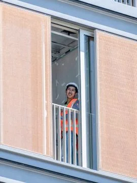 Smiling construction worker standing at new building window Stock Photos