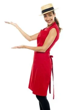 Smiling cook presenting copy space, open palms Stock Photos