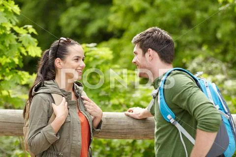 Smiling couple with backpacks in nature Stock Photos