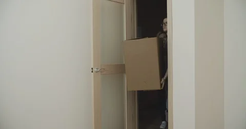 Smiling couple carrying on boxes in new home. Family cocept. Filmed on Sony 12 Stock Footage 123653165