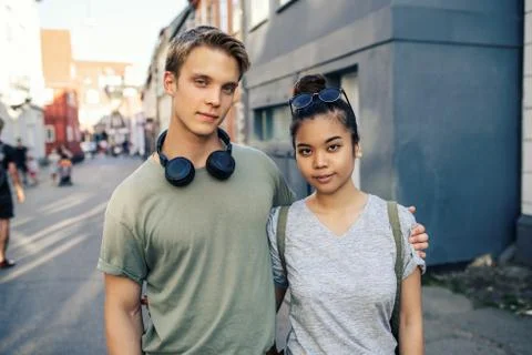 Smiling couple holding hands while standing in the city Stock Photos