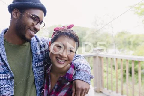 Smiling couple hugging on deck Stock Photos