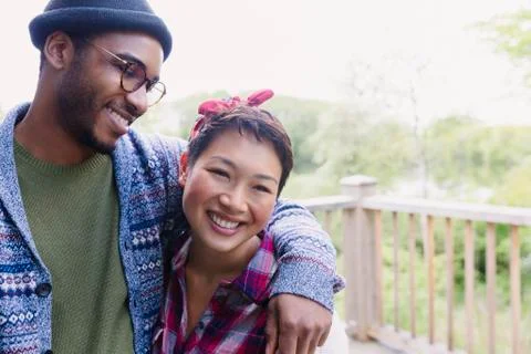 Smiling couple hugging on deck Stock Photos