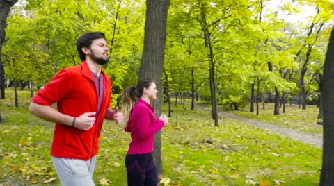 Smiling couple jogging in the autumn park slow motion Stock-Footage 59798009