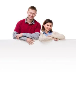 Smiling couple lean on empty blanket for ad Photos
