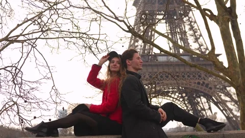 Smiling couple posing near Eiffel Tower in winter Stock Footage 314041153