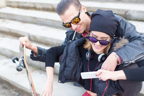 Smiling couple reading something funny on the internet. Stock Photos