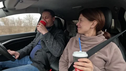 Smiling couple riding car talking drinking coffee together closeup countryside Stock Footage 270513594