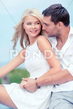 Smiling couple at sea side Stock Photos