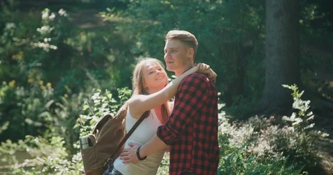Smiling couple spending time in woods. Stockbeeldmateriaal 81630071
