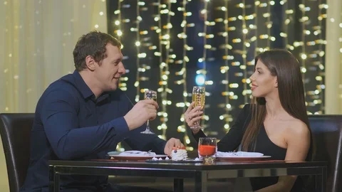 Smiling couple spends evening time sitting in cafe Video stock 125930708